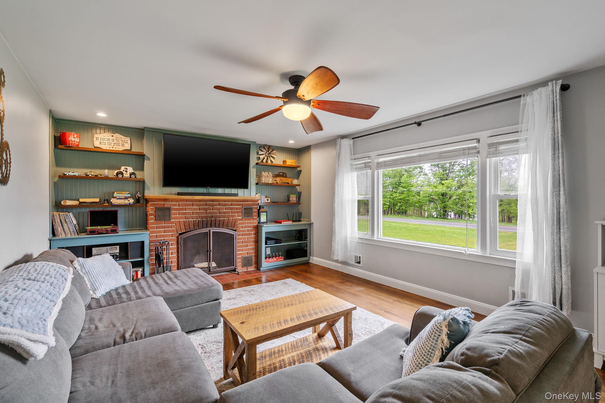 1327 County Rte 17 Montgomery, NY 12549 - Photo 13 of 37 a living room with furniture a fireplace and a flat screen tv