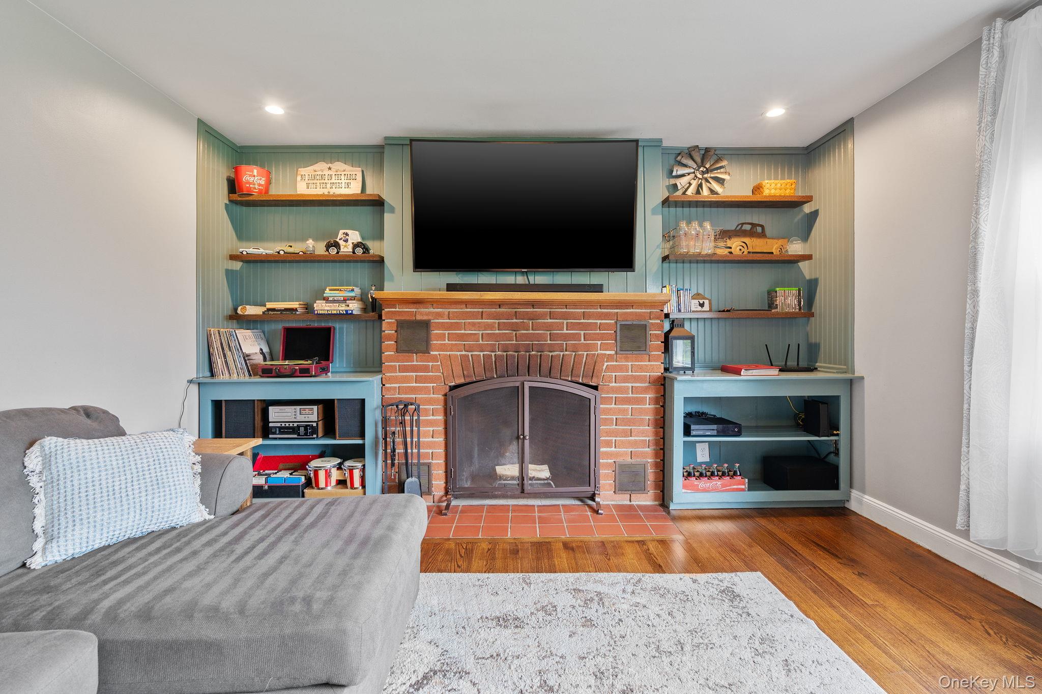1327 County Rte 17 Montgomery, NY 12549 - Photo 14 of 37 a living room with furniture a flat screen tv and a fireplace