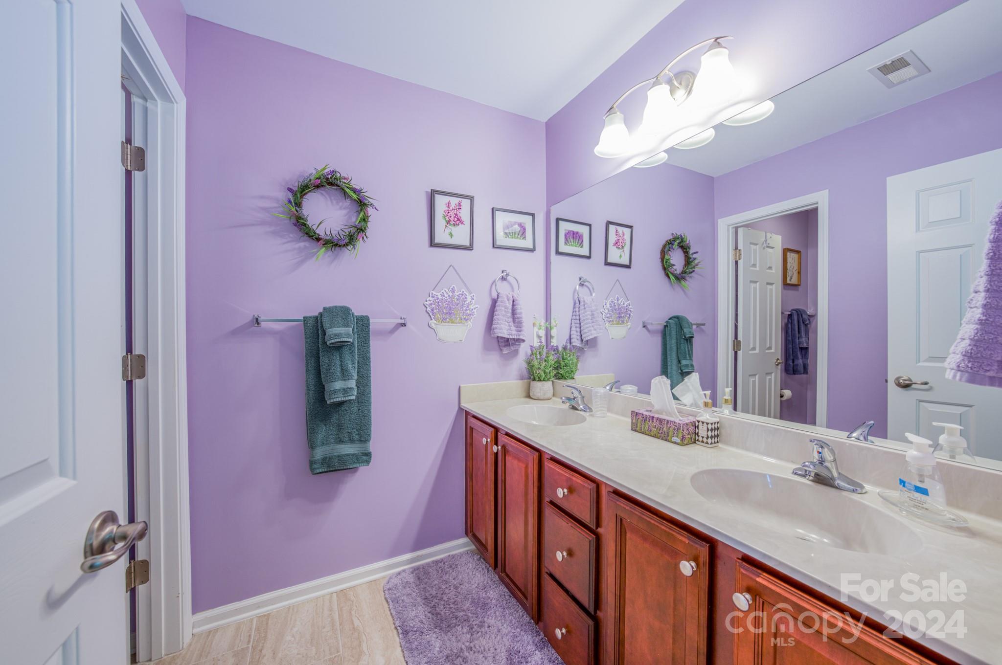 234 Roanoke Road Fletcher, NC 28732 - Photo 16 of 24 a bathroom with a granite countertop sink a mirror and vanity