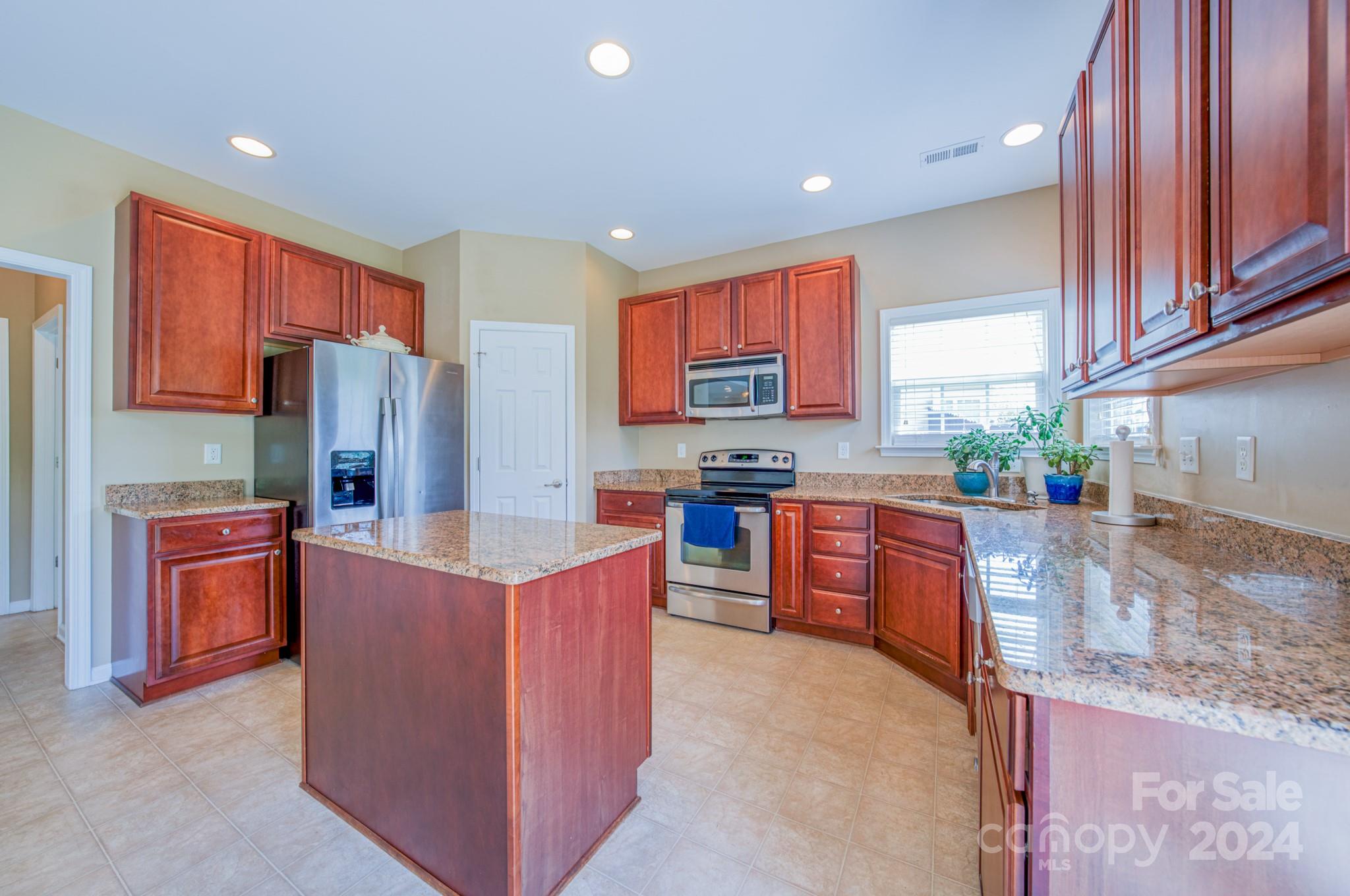 234 Roanoke Road Fletcher, NC 28732 - Photo 5 of 24 a kitchen with stainless steel appliances granite countertop a stove refrigerator and a sink