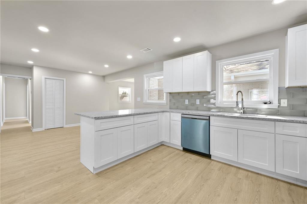 1963 Shepherd Circle Southwest Atlanta, GA 30311 - Photo 12 of 40 a kitchen with granite countertop a sink stainless steel appliances and cabinets