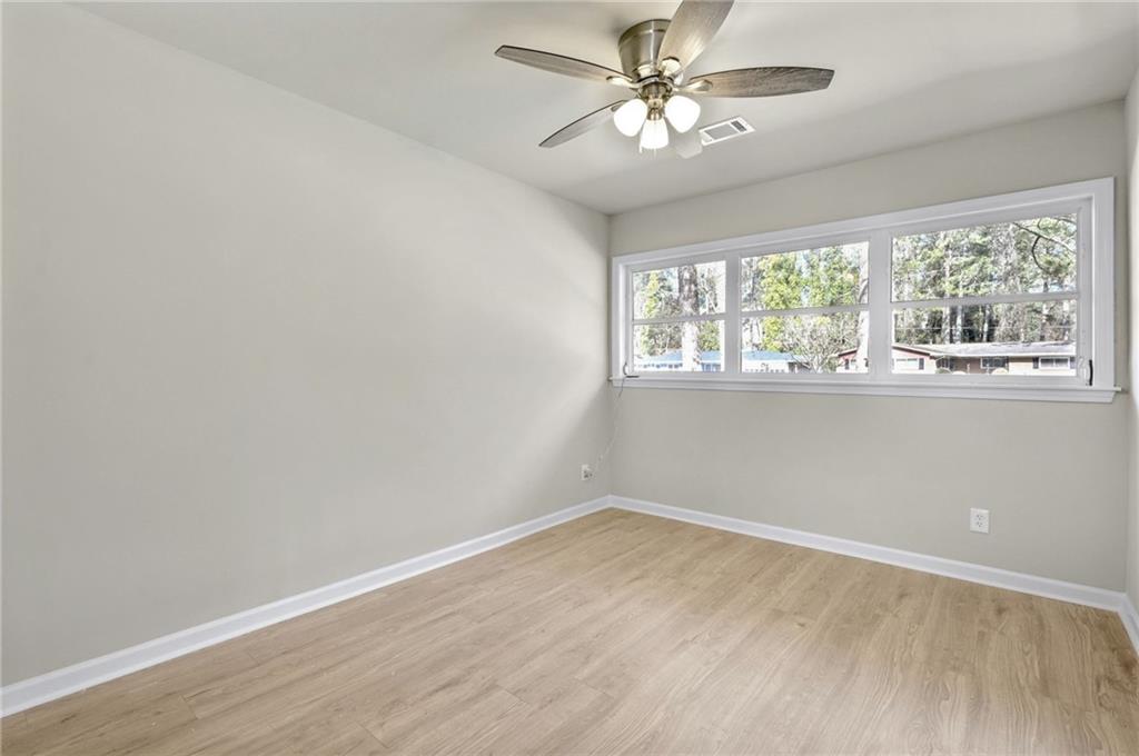 1963 Shepherd Circle Southwest Atlanta, GA 30311 - Photo 17 of 40 wooden floor in an empty room with a window