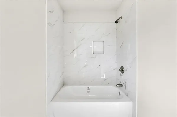 a white bath tub sitting next to a white sink