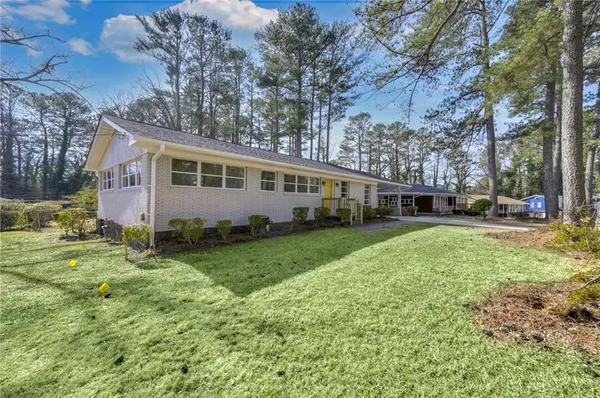 a front view of house with yard and green space
