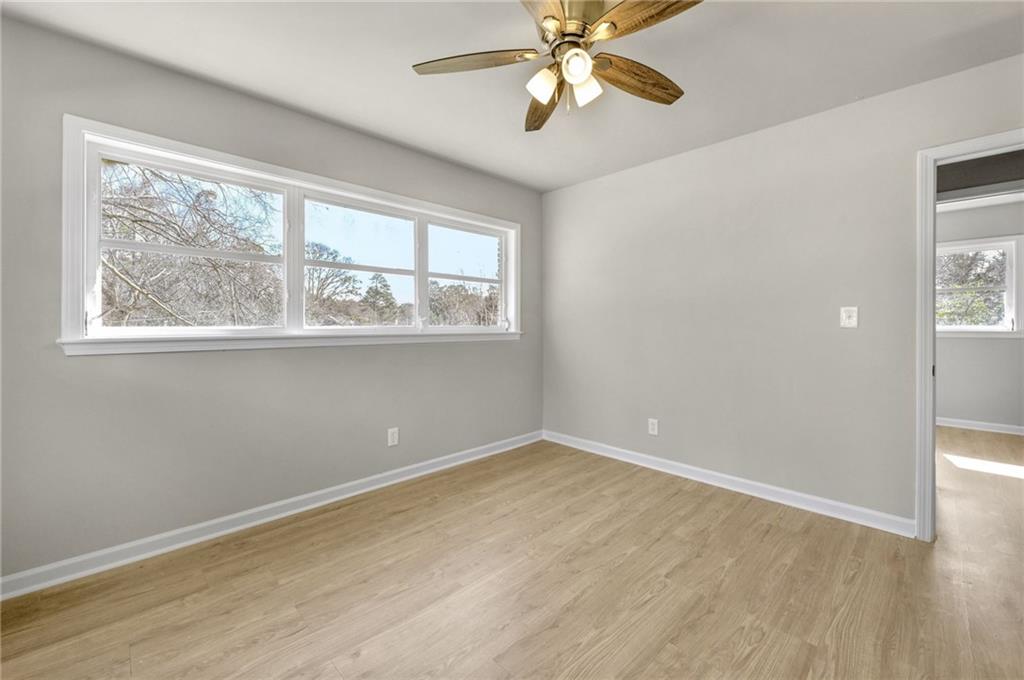 1963 Shepherd Circle Southwest Atlanta, GA 30311 - Photo 23 of 40 a view of an empty room with a window and wooden floor