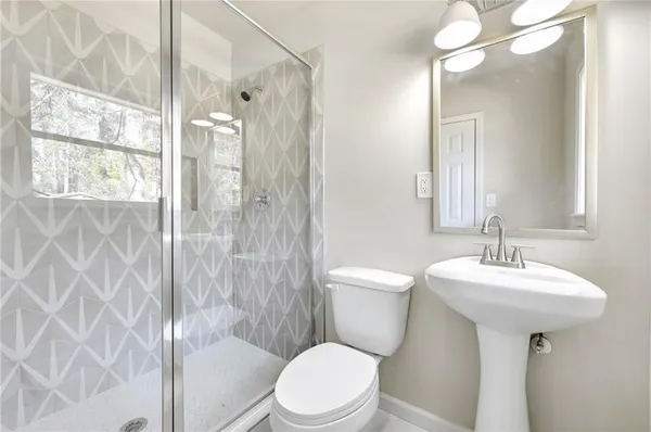 a bathroom with a sink toilet