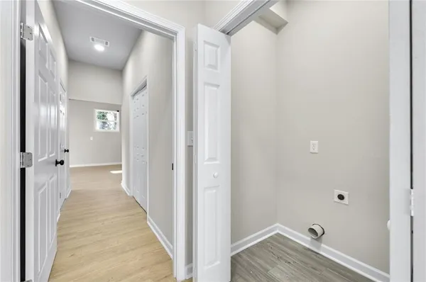 a view of a hallway with wooden floor
