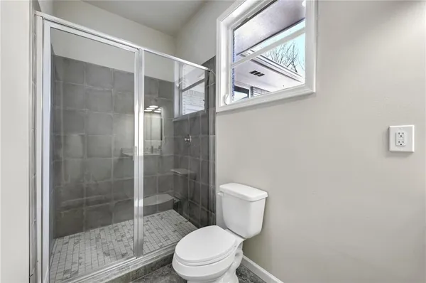 a white toilet sitting next to a bathroom sink