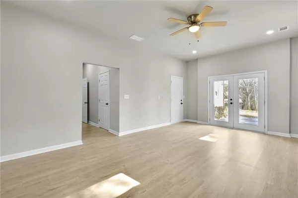 wooden floor in an empty room with a window