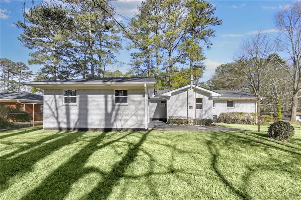 1963 Shepherd Circle Southwest Atlanta, GA 30311 - Photo 37 of 40 a house view with a sitting space and garden