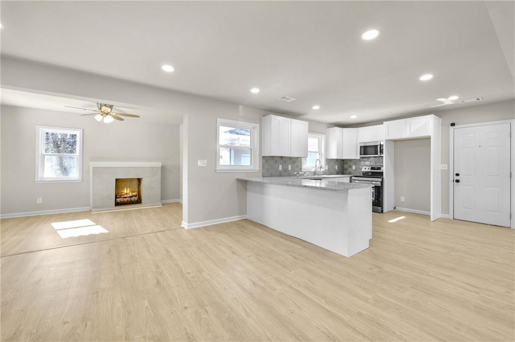 1963 Shepherd Circle Southwest Atlanta, GA 30311 - Photo 9 of 40 a view of kitchen with kitchen island wooden floor center island and stainless steel appliances