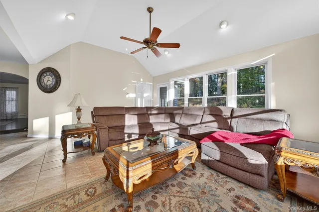 a living room with furniture a table and a clock