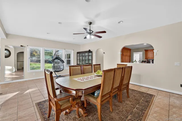 a view of a dining room with furniture and a chandelier