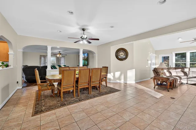 a view of a dining room and livingroom with furniture wooden floor and a rug