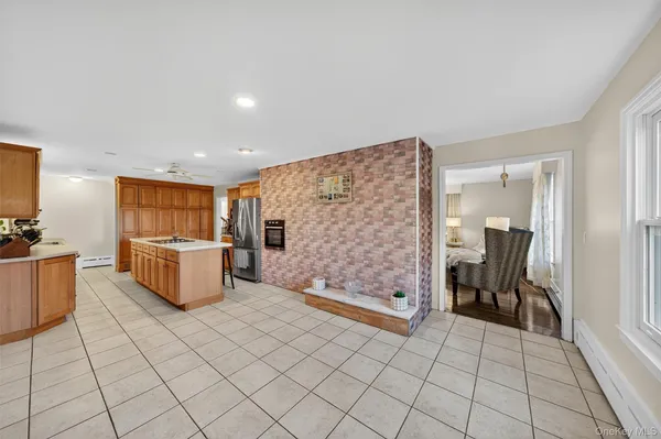 a kitchen with stainless steel appliances a refrigerator and a stove top oven