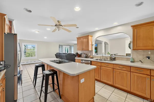a kitchen with a sink a counter space appliances and cabinets