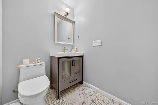 a bathroom with a toilet a sink and mirror