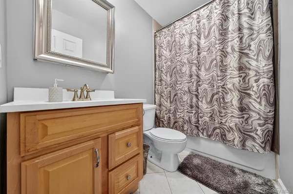 a bathroom with a sink toilet and a mirror