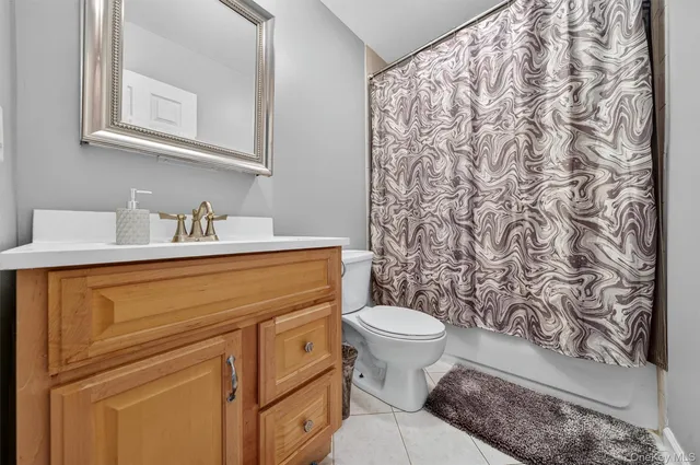 a bathroom with a sink toilet and a mirror