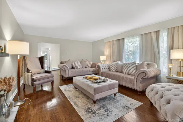 a living room with furniture and a lamp