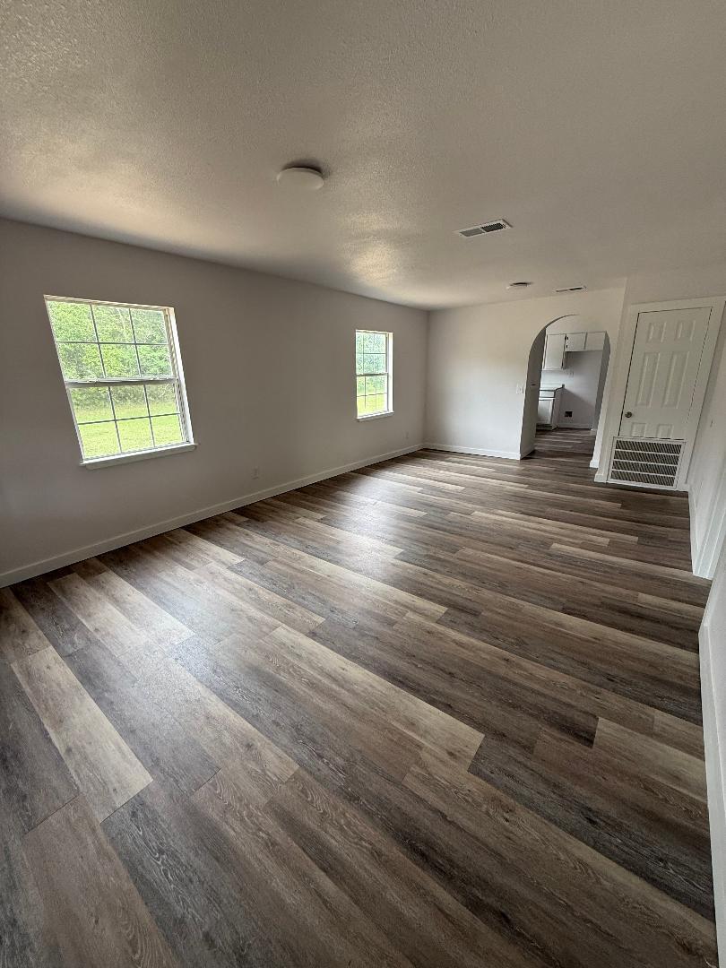 200 North Pleasant Street Geneva, AL 36340 - Photo 6 of 19 a view of a livingroom with wooden floor