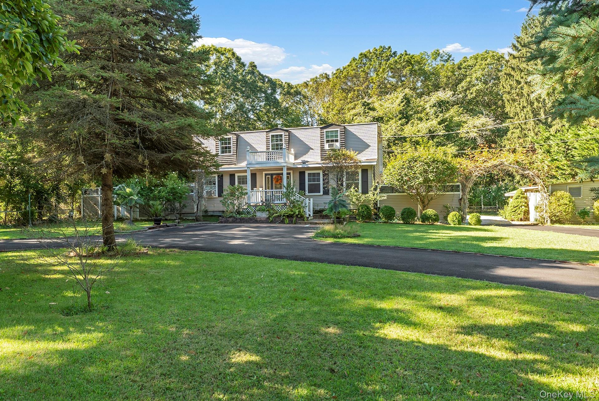 18 Glade Road Springs, NY 11937 - Photo 2 of 12 a front view of a house with a garden