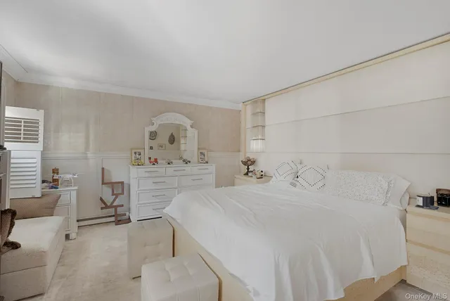 a bedroom with a bed a table and chair