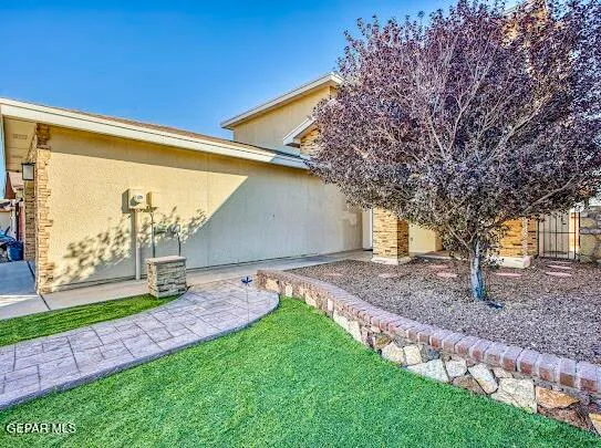 a large kitchen with stainless steel appliances kitchen island granite countertop a refrigerator and a sink