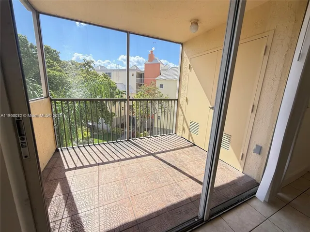 a view of a balcony with wooden floor and door