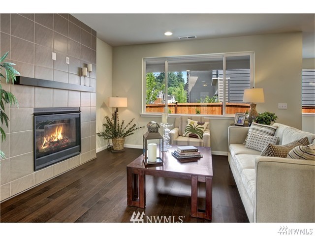 4305 223rd Place Southeast Bothell, WA 98021 - Photo 3 of 10 a living room with furniture a fireplace and a large window