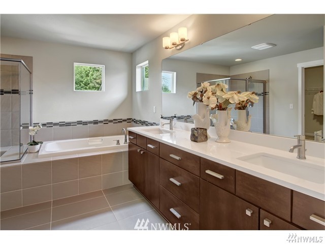 4305 223rd Place Southeast Bothell, WA 98021 - Photo 6 of 10 a bathroom with a tub sink and mirror