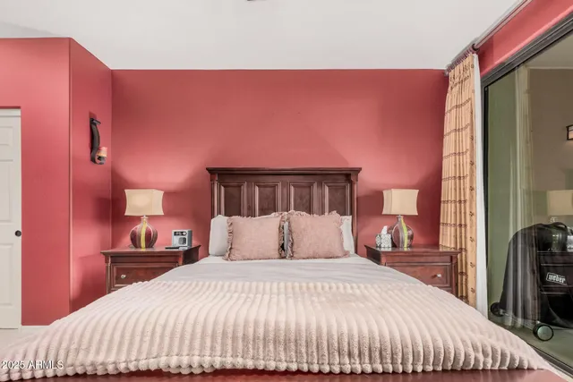 a bedroom with a bed and a television