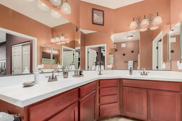 a bathroom with a sink vanity and a mirror