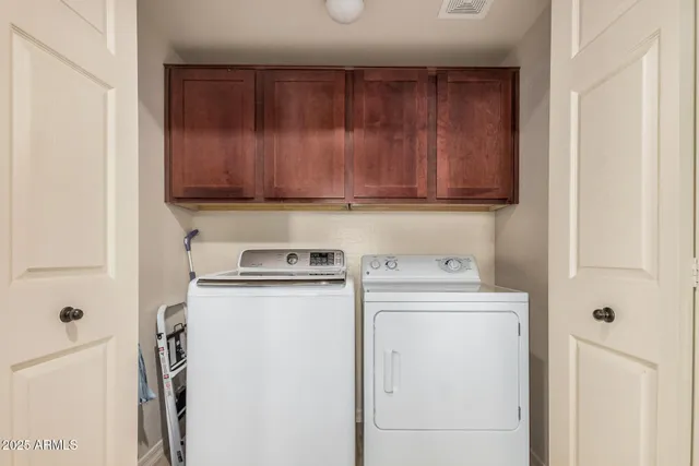 a view of a storage and utility room with a washer dryer