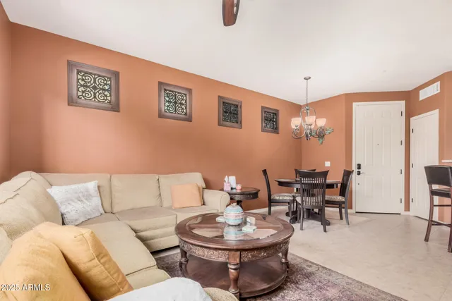 a living room with furniture a dining table and chairs