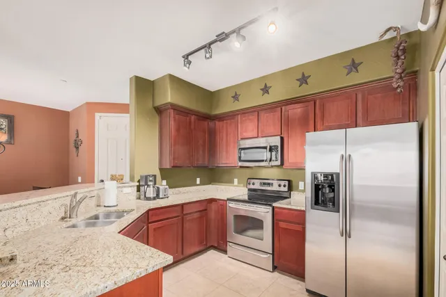 a kitchen with a refrigerator sink and stove