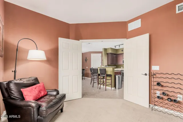 a living room with furniture a rug and white walls
