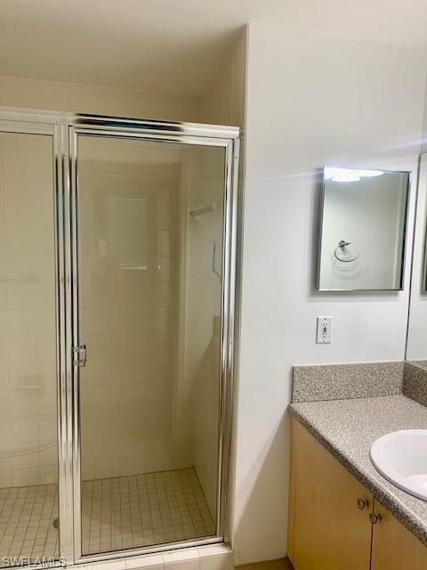 1180 Reserve Way, Unit 206 Naples, FL 34105 - Photo 9 of 22 a bathroom with a granite countertop shower and a sink