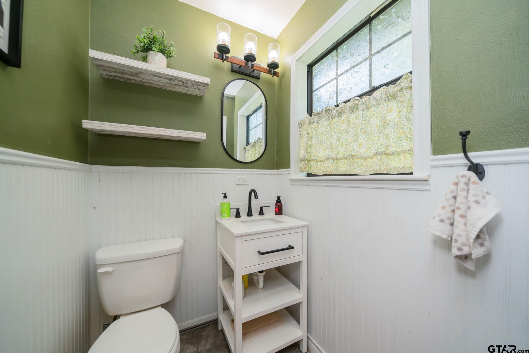 141 Cedar Street Rusk, TX 75785 - Photo 11 of 44 a bathroom with a toilet sink and mirror
