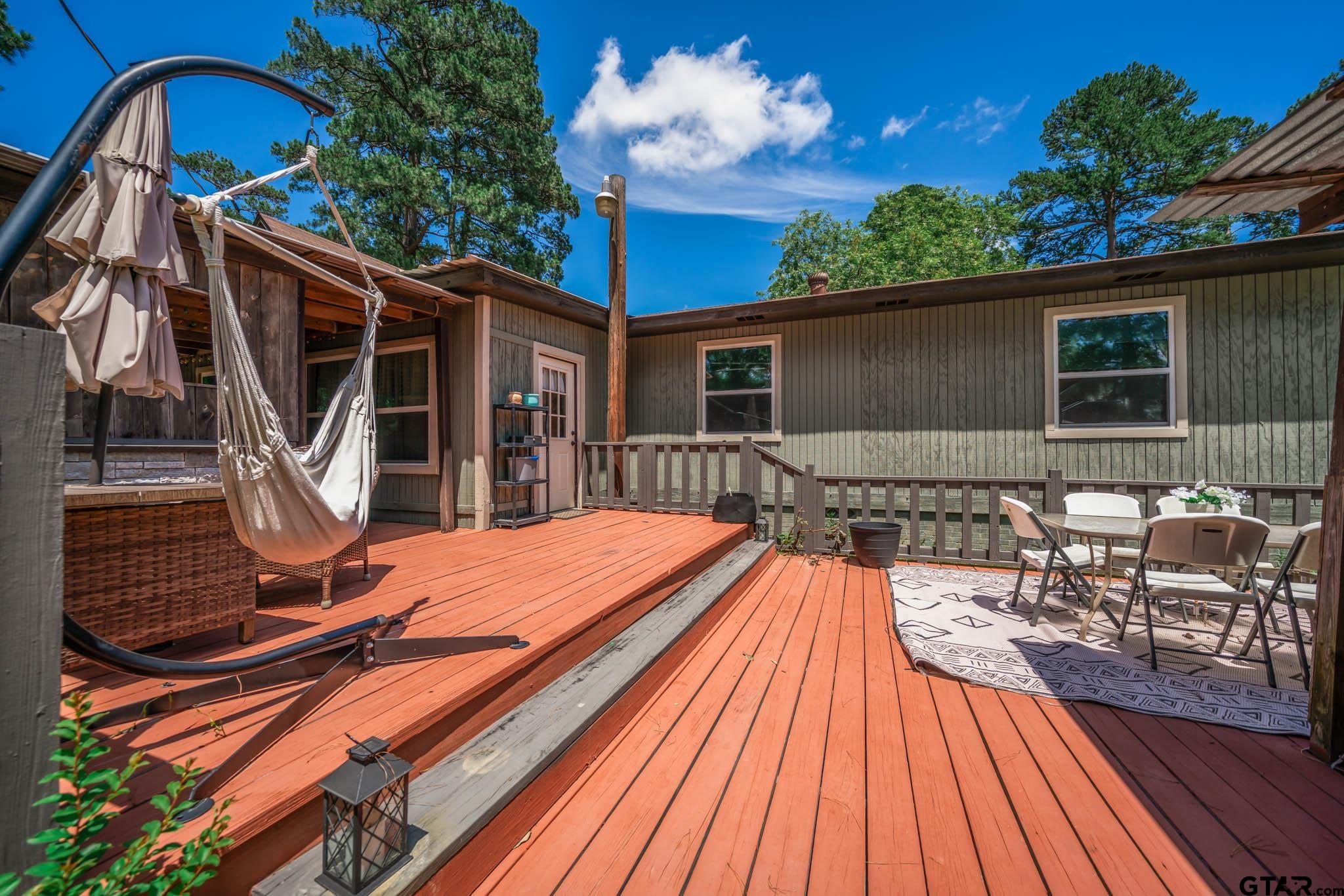 141 Cedar Street Rusk, TX 75785 - Photo 12 of 44 a backyard of a house with wooden floor potted plants and outdoor seating