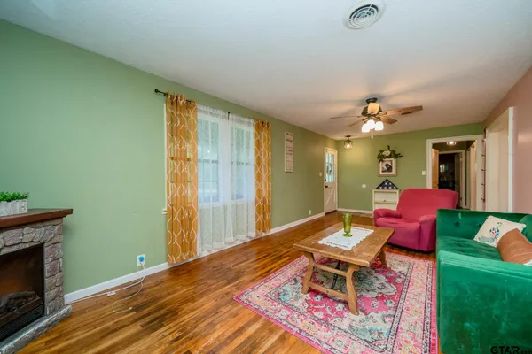 a living room with furniture and a fireplace