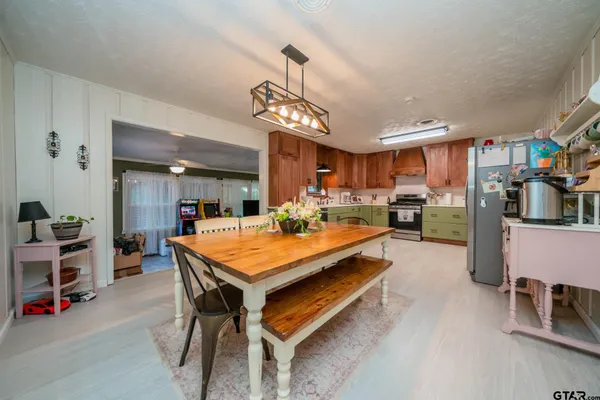 a room with furniture a flat screen tv and a chandelier