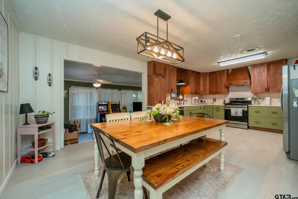 a kitchen with a dining table and chairs
