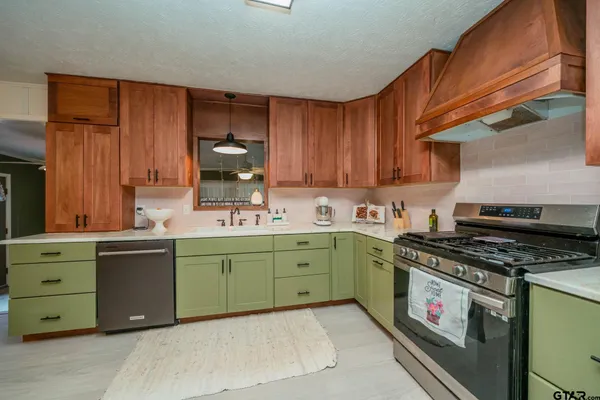 a kitchen with cabinets a stove and a sink