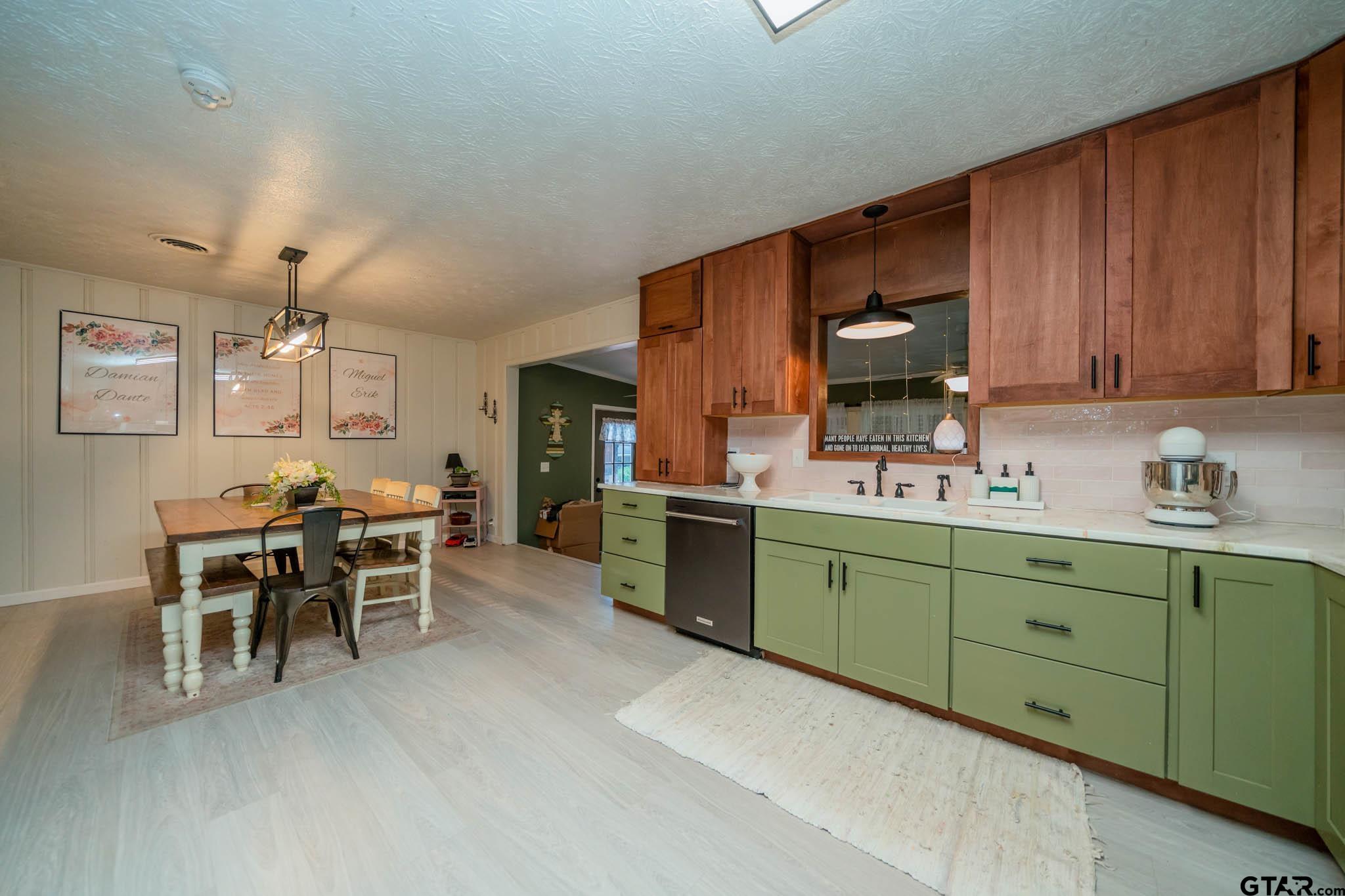 141 Cedar Street Rusk, TX 75785 - Photo 32 of 44 a kitchen with cabinets a sink and chairs