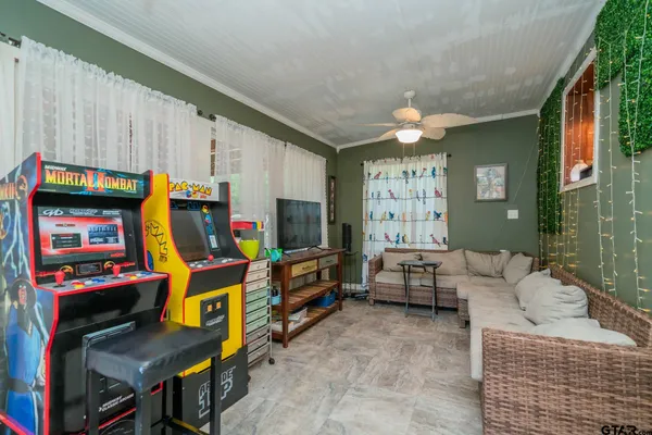 a living room with furniture a flat screen tv and a fireplace