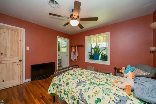 a bedroom with a bed and a window