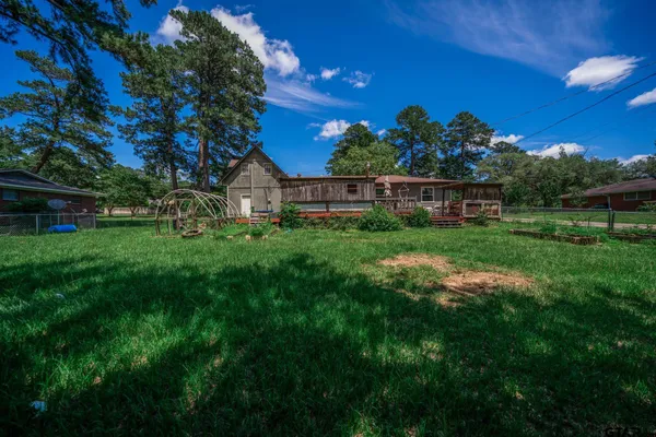 a view of a garden with a house in the background