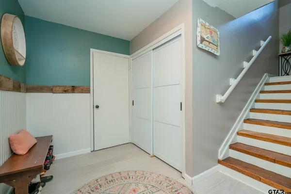 a view of a room with wooden floor and staircase