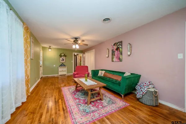 a living room with furniture and wooden floor
